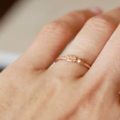 a woman's hand with a gold ring on it