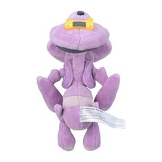 a purple stuffed animal with a tag on it's ear