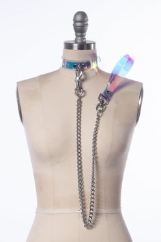 Magical, color-shifting iridescent choker collar made in thick PVC. Holographic, iridescent vinyl is layered over clear PVC.  Features a d-ring in center front. Fit is adjustable with buckle in back.   The leash clips on to the d-ring. The heavy-duty chain is 30" long, total length including the handle is 36" long. Collar is 1" wide. Silver toned hardware.  SMALL/MEDIUM (11-13") MEDIUM/LARGE (13-15") LARGE/X-LARGE (15-17") Custom sizing available.   Please allow 1-2 weeks for construction - Thes Holographic Iridescent, Gothic Choker, Pet Spaces, Gothic Chokers, Stunning Tops, Collars For Women, Choker Collar, Leather Pieces, Pastel Aesthetic