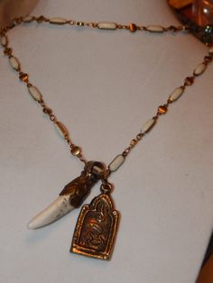 ivory coast collection unique one of a kind creation...Ivory colored bead and brass necklace with bone claw/fang and two sided brass buddha pendants...the chain is a sumptuous 36" long and the claw/fang pendant is approximately 1.5" and the buddha pendant is approximately 1.25" Boar Tooth Necklace, Red Priestess, Oddities Jewelry, Bird Lady, Aegon Targaryen, Buddha Necklace, Lady In Waiting, Bone Necklace, The Brotherhood