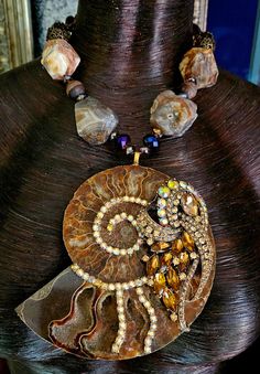 This gorgeous one-of-a-kind piece is from my private collection, and is unworn.  A gorgeous druzy pocket ammonite fossil is bejeweled with an ornate art deco style topaz rhinestone jewel and citrine aurora borealis rhinestones.  The pendant is suspended from an adjustable 16-19" statement necklace comprised of rough ag Rocker Chic Accessories, Bold Women, Jewellery Shop Design, Unique Pendant Necklace, Crystal Statement Necklace, Ammonite Fossil, Chest Piece, Mermaid Necklace, Beaded Bracelet Patterns