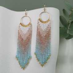 Elevate your style with these handmade beaded fringe earrings, crafted with sparkling brown, aqua blue, and gold-plated glass beads, hanging from 14k gold filled sparkling hoops and earring hooks. Accented with natural Ocean Apatite gemstones for a coastal-inspired elegance. Designed to capture the warmth and tranquillity of the beach, they bring natural beauty and a relaxed, sophisticated style to any look. ⧫  SIZE - Length: 4.1 in (10.5cm)  - Width: Hoop diameter is 0.7 in (18mm), Fringe width Ocean Beaded Earrings, Earring Inspo, Beaded Fringe Earrings, Beaded Earring, Gold Filled Hoops, Gold Alloys, Beading Ideas, Beaded Hoops, Beaded Fringe