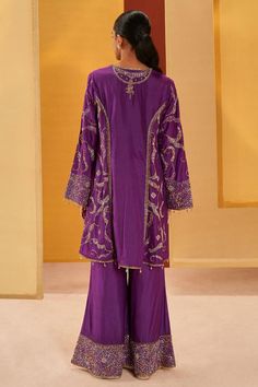 Purple silk organza A-line short kurta with vintage zardosi embroidery. Comes with pant and a slate grey dupatta.
Components: 3
Pattern: Embroidered
Type Of Work: Zardosi
Neckline: V Neck
Sleeve Type: Bell Sleeves
Fabric: Silk organza
Color: Purple
Other Details: 
Emboidered dupatta
Note : Outfit worn by the model on the left is not for sale.
Occasion: Mehendi and Haldi - Aza Fashions Elegant Purple Chanderi Palazzo Set, Eid Organza Sharara, Purple Georgette Palazzo Set, Elegant Purple Palazzo Set For Festivals, Dabka Palazzo Set For Reception, Purple Silk Set With Sheer Dupatta, Elegant Purple Long Sleeve Palazzo Set, Elegant Long Sleeve Purple Palazzo Set, Elegant Purple Silk Sharara