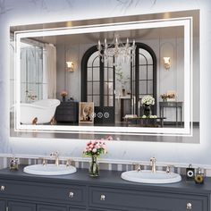 a bathroom with two sinks and a large mirror over it's sink area that has a chandelier hanging from the ceiling