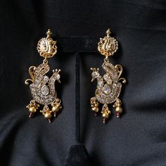 Brass alloy with white stonework. Product Dimensions (inches): L: 3 B: 1.5 H: 0.655 Traditional Metal Earrings For Formal Occasions, Gold Earrings With Stone Work, White Stone Work Earrings For Formal Occasions, Silver Jeweled Earrings For Festive Season, Formal Metal Jewelry With Stone Work, Elegant Silver Jeweled Danglers, Festive Hand Set Metal Earrings, Elegant Gold Jeweled Danglers, Silver Gold-plated Earrings With Stone Work