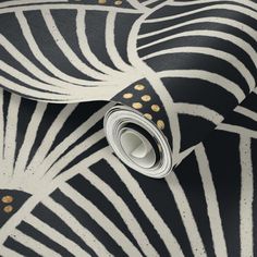 a black and white zebra print wallpaper with gold dots on it's edges