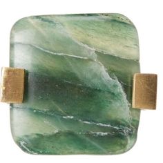 a green and gold ring with waves in the water on it's side,