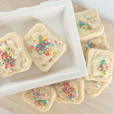 small square cookies with sprinkles on a white plate