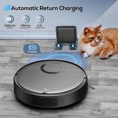 a cat laying on the floor next to a robotic vacuum