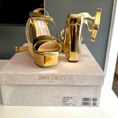 Never Worn, Brand New Gold Jimmy Choo Sandals! Mint Condition, Size 6 1/2! Designer Gold Sandals With Wrapped Heel, Designer Gold Sandals With Heel Loop, Luxury Gold Platform Heels, Luxury Gold Platform Sandals, Designer Gold Platform Sandals, Designer Gold Wedge Heels, Designer Platform Sandals For Party, Luxury Party Sandals With Wedge Heel, Designer Gold Heels With Wrapped Heel