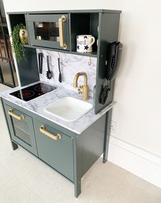 a kitchen with an oven, sink and cupboards in it's display area