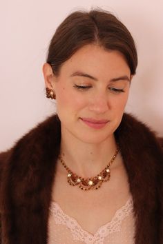 This sweet little necklace is an autumn dream! We love the warm brown stones set with aurora borealis for that extra sparkle! The necklace is short at 15 inches (or shorter for the ultimate choker look) The perfect necklace to wear for Thanksgiving dinner!  Necklace: 1960's  One-of-a-kind Brown & Aurora Borealis Rhinestones  15 inches length max (adjustable - shorter for a choker vibe) Excellent Vintage Condition *All items are carefully cleaned. *Emma London Vintage is unable to accept returns Luxury Vintage Brown Necklace, Dinner Necklace, Vintage Rhinestone Necklace, Little Necklace, London Vintage, Brown Necklace, Vintage London, Warm Brown, Rhinestone Necklace