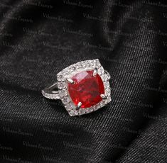 Main Stone - Natural Ruby Gemstone  Main Stone Size - 10 mm Cushion Cut  Carat Weight - 5 Ct. + Secondary Stone - Synthetic American Diamonds Metal - 22 Carat White Rhodium plating over 925 Sterling Silver Ruby is the July  birthstone. Dispatch Time - 1 to 3 days Deliver Time - 11-23 working days PayPal - We accept only PayPal payment method. Return Policy- 30 Days Return policy ( Item Damaged/Not in proper Size/Incorrect Item Send ) We always believe in customer satisfaction, we request you to please mark a message us for any concern before escalate it to Etsy, we always try to solve it ASAP. July Birthstone Ring, Red Band, July Birthstone, American Diamond, Ruby Gemstone, Red Ruby, Ring Promise, Ruby Ring, Natural Ruby