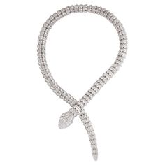 Bulgari Serpenti diamond snake necklace in 18k white gold, accompanied by Bulgari box. This striking Bulgari Serpenti piece features approximately 73.81 carats of round brilliant cut diamonds pave set over the entirety of the necklace, as well as 2 pear shape diamond eyes weighing approximately 1.00 carat. Total, there is approximately 74.81 carats. Numbered and signed BVLGARI. Bulgari Serpenti Viper Necklace, Snake Necklace Bulgari, Bulgari Jewelry Snake, Snake Diamond Necklace, Bvlgari Jewelry Aesthetic, Bulgari Snake Necklace, Bvlgari Snake Necklace, Bvlgari Serpentine Necklace, Bvlgari Necklace Snake