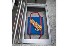 a blue and red handbag sitting on top of a metal floor next to a door