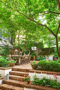 an outdoor patio with steps leading up to it and lots of greenery on the side