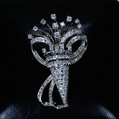 "Absolutely stunning Art Deco era platinum and 124 excellent quality diamonds Tremblant brooch! The bouquet diamonds are set in an articulated \"tremblant\" setting. The brooch comes in its original fitted leather and velvet case. Measurements: 2 diamonds diameter 3mm (0,11\") 8 diamonds diameter 2,25mm (0,08\") 4 diamonds diameter 2mm (0,07\") 108 diamonds diameter 1,5mm (0,05\") Total carat weight is approximately 1.72 carats approximate width 3,5cm (1,37\") Approximate height 5,5cm (2,16\") t Fine Jewelry Diamond Brooch With Brilliant Cut, Diamond Brooch With Brilliant Cut, Diamond Brooches With Brilliant Cut In Fine Jewelry Style, Classic Diamond Brilliant Cut Brooch, Classic Diamond Brooch With Brilliant Cut, Classic Diamond Brooches With Brilliant Cut, Diamond Brilliant Cut Brooch For Anniversary, Diamond Brilliant Cut Brooches For Anniversary, Brilliant Cut Diamond Brooch For Anniversary