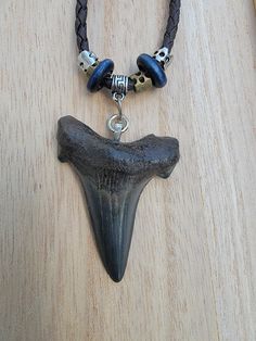 Hand picked Angustidens Shark Tooth made onto a brown leather and rope sliding knot adjustable necklace! Tooth size is 2 1/4 inches long! Perfect condition! Est age 33 million years! Brown Necklace With Sliding Knot For Gift, Adjustable Brown Necklaces With Sliding Knot, Artisan Brown Jewelry With Sliding Knot, Adjustable Brown Necklace With Sliding Knot, Rustic Brown Jewelry With Adjustable Cord, Casual Brown Necklace With Adjustable Cord, Sharks Tooth Jewelry, Gold Shark Tooth Necklace, Rustic Brown Waxed Cord Necklace