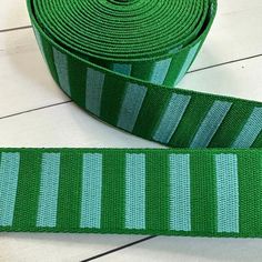 a green ribbon with white stripes on it