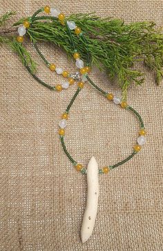 Unique and very rare little silver birch root talismanic necklace. On a necklace chain of moss green seed beads, set with pale green crystal, yellow chalcedony and beautiful 8mm white jade beads. And one lightly dotted silver birch root double terminated talismanic point. The tree of light and hope, of renewal and nurture, like all roots, this piece holds unformed and unshapen energy, an energy that can be shaped according to the desires of the wearer. This piece holds blinding white energy,, a Nature-inspired Crystal Necklaces With Gemstone Beads For Healing, Nature-inspired Gemstone Beads Necklace As Gift, Nature-inspired Gemstone Beaded Necklaces As Gifts, Nature-inspired Gemstone Beads Necklace For Gift, Nature-inspired Beaded Necklace With Gemstone Beads For Gifts, White Jade Beaded Necklace With Gemstone Beads, Handmade White Jade Necklaces, Nature-inspired Beaded Necklaces For Healing With Natural Stones, Handmade White Jade Beaded Necklaces