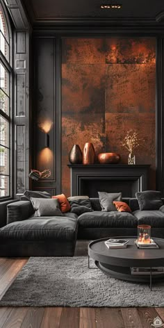 a living room with black walls and wooden floors, large couches and coffee table