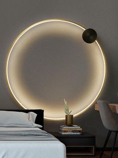 a bedroom with a bed and a round light on the wall