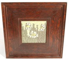 an old wooden frame with flowers in it on a white background, and the image is made from wood