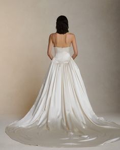 a woman in a white wedding dress looking back