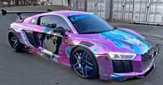 a pink and blue car parked on the street