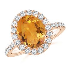 The prong set oval citrine evokes the alluring hue of the sunshine. A glimmering halo of diamonds encircles the center stone, adding a luxurious touch to this oval citrine ring in 14k rose gold. The shoulders are also embellished with diamonds for enhanced beauty. Ring With Diamond, Citrine Ring, Halo Ring, Halo Rings, The Sunshine, 18k Rose Gold, Prong Setting, Citrine, Gemstone Jewelry