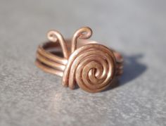 Humble but efective and extraordinary copper wire ring. Like in the pictures made of copper wire diameter 1,2mm. Instead of gemstone there is a little snail made of wire. This little gadget will surely get attention of Your friends on the party or used as an everyday wear. Variety of sizes availabel - please specify the diameter You are intrested in. Opinions about the healthy effects of copper on the human body are quite popular and many of them can be found in the internet. Buying our ring, You receive in addition to potential health properties also a nice piece of exclusive jewelry, which is suitable for everyday wear as well as for special occasions, especially among those who appreciate the uniqueness of handcrafts. Cleaning: This is uncoated copper so it will tarnish. Many people lik Wire Wrapped Jewelry Rings, Copper Wire Ring, Copper Wire Crafts, Diy Wire Jewelry Rings, Wire Jewelry Rings, Wire Craft, Wire Jewelery, Wire Wrap Jewelry Designs, 2024 Ideas