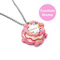 "This Happy Birthday Necklace is a perfect handmade cute charm jewelry birthday gift for your best friend or any woman in your life! Perfectly pink and kawaii, this cake pendant is made from resin and features a high quality gold finish stainless steel chain. This is a custom name necklace, with your chosen name on top of the cake in pink cursive style lettering. Includes free pink and holographic logo gift box to celebrate your favorite friend or loved one. Style & Personalized Initial: -Cake h Personalized Pink Necklaces For Best Friend Gift, Playful Charms Jewelry For Birthday, Cute Charms Necklace For Gift, Cute Charms Necklaces For Gifts, Cute Charms Necklaces As Gift, Customized Pink Novelty Jewelry, Handmade Charm Necklace For Birthday And Mother's Day, Fun Pink Charm Necklaces, Handmade Cute Charm Necklaces For Mother's Day