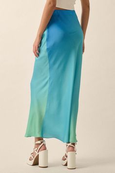 Ombre satin maxi skirt. High waist. Bias cut. Invisible zipper side closure. Straight silhouette. Ankle length. Relaxed fit. 100% Polyester. Imported. Designed in LA. Model wears size S. Spring Full-length Satin Skirt, Fitted Bias Cut Maxi Skirt For Summer, Wide Leg Satin Skirt For Spring, Blue Maxi Length Party Bottoms, Summer Satin Maxi Skirt With Lining, Spring Satin Maxi Skirt, Blue Maxi Length Bottoms For Party, Chic Blue Full-length Maxi Skirt, Chic Blue Full Length Maxi Skirt