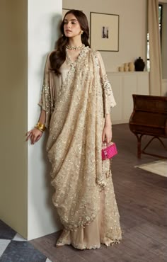 Golden Embellished Pakistani Wedding Dress in Raw Silk is a stylish masterpiece adorned with Hand-crafted details of Sequins, Beads, Sitara, and Motifs. Fancy Kaftan Dress, Wedding Embellished Pre-draped Saree In Chinon, New Dresses Designs Pakistani, Eid Reception Traditional Wear With Sequins, Anarkali Embellished Pre-draped Saree For Wedding, Embellished Pre-draped Saree For Eid Wedding, Eid Wedding Pre-draped Saree With Sequins, Eid Wedding Pre-draped Sequin Saree, Eid Wedding Embellished Pre-draped Saree