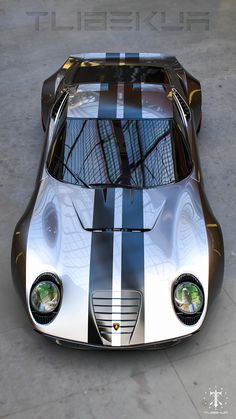 the front view of a silver and black sports car with stripes on it's hood