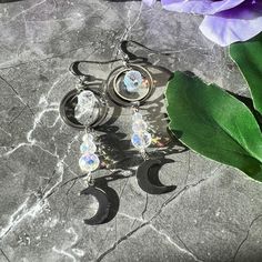 Shine bright like the goddess you are! These celestial moon earrings are sure to shine, and will give you a surprise with the sunlight.   Made with stainless steel and paired with a glass crystal bead, these earrings give a sparkle when the sun hits them, reminding you of a sun catcher! Light weight and perfect for every day wear or when you want to rock your celestial goddess side. Celestial Silver Pierced Crystal Earrings, Silver Moon-shaped Celestial Earrings, Silver Moon Shaped Celestial Crystal Earrings, Silver Moon Shaped Crystal Earrings, Celestial Moon Charm Crystal Earrings, Silver Celestial Crystal Earrings, Silver Moon-shaped Celestial Crystal Earrings, Nickel-free Celestial Crystal Earrings, Celestial Silver Crystal Earrings With Moon Charm