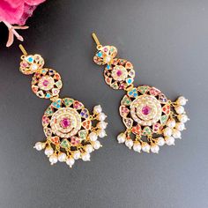 Featuring a jadau necklace with matched pair of long earrings in 22k Gold. The set is studded with navratan color stones. The necklace weighs 22.0 gms including 0.89 gms in the hanging pearl beads. The earrings weigh 14.53 gms including 1.79 gms in the hanging pearl beads. Price Breakup Summary Component Rupees % of Total 22k Gold 173,447 77.0% Stones & Beads 14,040 6.2% Making Charges 31,220 13.9% Taxes (GST) 6,561 2.9% Total 225,268 100.0% View Detailed Price Breakup Ceremonial 22k Gold Multicolor Jewelry, Traditional Gold Plated Multi-stone Jewelry, Traditional Multi-stone Gold Plated Jewelry, Multicolor 22k Gold Fusion Jewelry, Multicolor Gold Plated Kundan Necklace With Meenakari, Multicolor Meenakari Kundan Necklace Gold Plated, Multicolor Gold Plated Jewelry For Diwali, Multicolor Gold Plated Bollywood Jewelry, Multicolor Gold Plated Jewelry Sets For Festivals