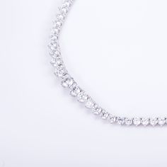 Timeless elegance with 123 exquisite diamonds, expertly hand-linked for seamless perfection. Featuring the highest color grade and a secure box clasp, this necklace is a true work of craftsmanship. Enhance any outfit with this stunning luxury piece. Diamond is set in 14k solid recycled white gold Width: 5.5mm in the center, 3mm to the ends Setting: 3 prong Total gold 25g, based on 16" Closure: Box clasp with 1 hidden latch AG Conflict-free, socially responsible diamonds. Color: D-F, Clarity: VVS Diamond Tennis Necklace, Box Clasp, Tennis Necklace, Color Grading, Lab Grown Diamonds, Timeless Elegance, Solid Gold, Fine Jewelry, Product Launch