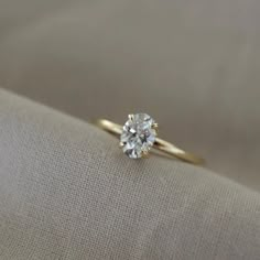 a diamond ring sitting on top of a cloth