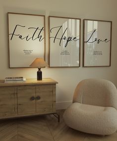 two framed posters on the wall above a dresser with a chair in front of it