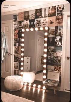 a large mirror with lights on it in a room