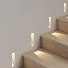 the light is shining through the windows on the wall next to the stair treads