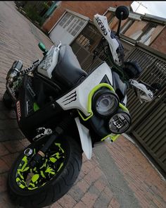 a white and black motorcycle parked next to a building