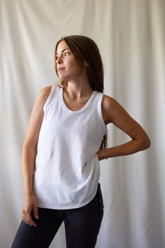 Basic Everyday Cotton Tank Top, White Seamless Crew Neck Tank Top, Basic Cotton Tank Top With Scoop Back, White Seamless Top With Scoop Back, White Seamless Tops With Scoop Back, White Seamless Scoop Back Top, Everyday Fitted White Muscle Tee, White Scoop Neck Tank Top For Layering, Basic Crew Neck Tank Top