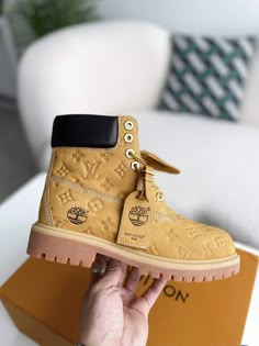 Elevate your style and conquer any terrain with these Timberland-inspired boots, reimagined with the iconic Louis Vuitton monogram. Crafted with premium leather and meticulous attention to detail, these boots offer a unique blend of rugged functionality and high-fashion flair. Step out in confidence and express your individuality with this statement-making footwear. Louis Vuitton Timberland Boots, Botas Louis Vuitton, Ashley Furniture Sectional, Bad And Boujee Outfits, Clothes Haul, Timberland 6 Inch, Hoodies Graphic, Nike Streetwear, Fall Winter Jacket