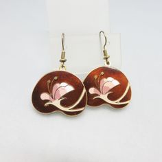 These fun Cloisonne' Enamel Earrings are done in goldtone metal with a white and pink flower against a rich brown background. The earrings are French hook style and are in near mint condition.  They are not marked. They measure 1 5/8ths inches tall and 1 1/8ths inches wide.  We will send these to you in a lovely gift box for easy gift giving If you like vintage accessories, vintage costume jewelry, old bolo ties and silver jewelry,  please see my Etsy store for more selections, www.etsy.com/shop Vintage Rose Gold Flower Earrings, Retro Brown Jewelry For Gift, Vintage Brown Flower-shaped Jewelry, Vintage Metal Flower Earrings, Vintage Pink Flower-shaped Earrings, Brown Flower Drop Earrings, Vintage Pink Nickel-free Flower Earrings, Vintage Gold Flower Earrings With Enamel, Vintage Gold Flower Earrings For Gift