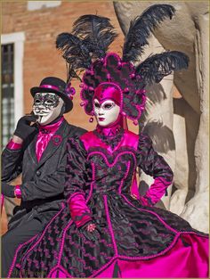 two people dressed up in costumes and masks