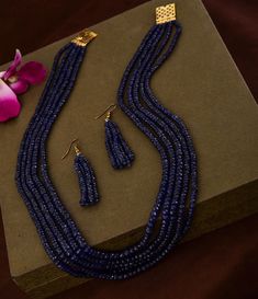 Natural Genuine Dark Blue Sapphire Beaded Necklace With Earrings NW : 600 carats GW : 625 carats No. Of Layers : 5 Model Image Necklace Length : 16-18 inches 1 gm 18k Gold Clasp Set in Sterling Silver 925 Non-Tarnishable Skin Tested 18k Gold Plated Clasp To Avoid Any Tarnishing Provided with GRS Lab Certification Real Time Image. No Tampering **Please note all the gemstones we use at RiyaJewels are completely natural , unheated and non-treated* Riya Jewels Has Set New Standards In Contemporary S Elegant Sapphire Beaded Necklaces With Gemstones, Elegant Sapphire Beaded Necklace With Gemstone, Luxury Blue Beaded Necklace With Polished Beads, Luxury Blue Polished Beads Necklace, Dark Blue Necklace, Elegant Sapphire Faceted Beaded Necklaces, Elegant Sapphire Round Bead Jewelry, Luxury Blue Jewelry With Polished Beads, Elegant Sapphire Jewelry With Round Beads