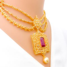 Crafted with exquisite attention to detail, this 22k yellow gold set weighs 54.8 grams and features a royal vintage design. It is adorned with uncut diamonds (Polki), totaling 11.18 carats, and further embellished with rubies and pearls, collectively weighing 34.2 carats. The set has a length of 16 inches, with an impressive drop length of 2.2 inches, and is secured with a hook lock and adjustable links for tailored comfort. The matching earrings, at a length of 2.1 inches, complete the set, eac Yellow Gold Kundan Pendant Necklace For Wedding, Wedding Yellow Gold Kundan Pendant Necklace, Gold Temple Necklace With Pearl Pendant, Gold Chandbali Bridal Necklace With 17 Jewels, Gold Temple Necklace With Stone Work For Ceremonial Use, Ceremonial Gold Temple Necklace With Stone Work, Luxury Gold Chandbali Necklace, Luxury Gold Necklace With Stone Work, Festive Gold Kundan Necklace With Ruby