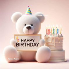 a white teddy bear sitting next to a birthday cake with candles on it and a sign that says happy birthday